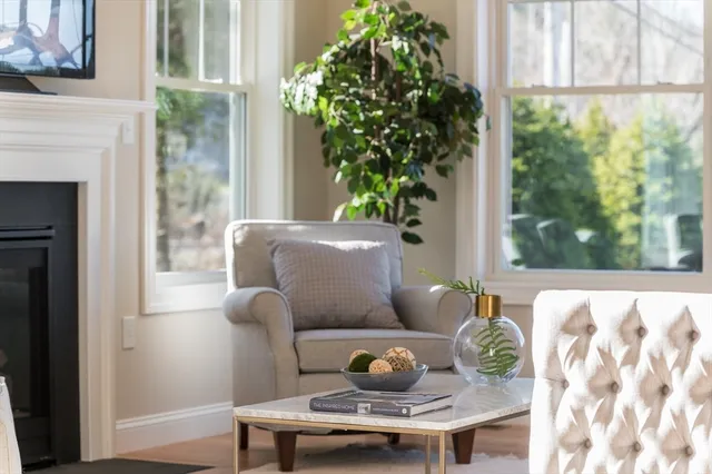 a living room with furniture large window and a fireplace