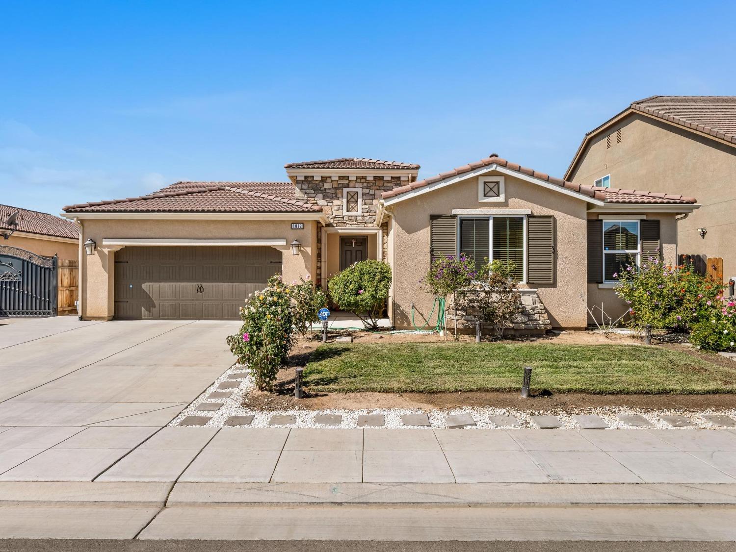 a front view of a house with garden