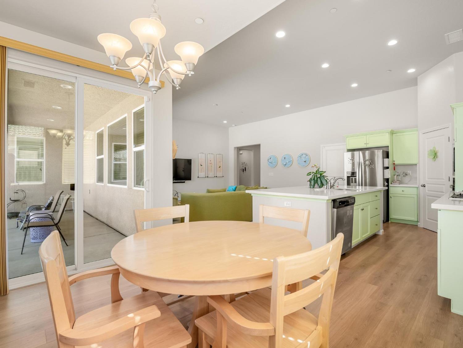 1012 Las Rosas Avenue Clovis, CA 93619 - Photo 11 of 36 a view of a dining room with furniture and wooden floor