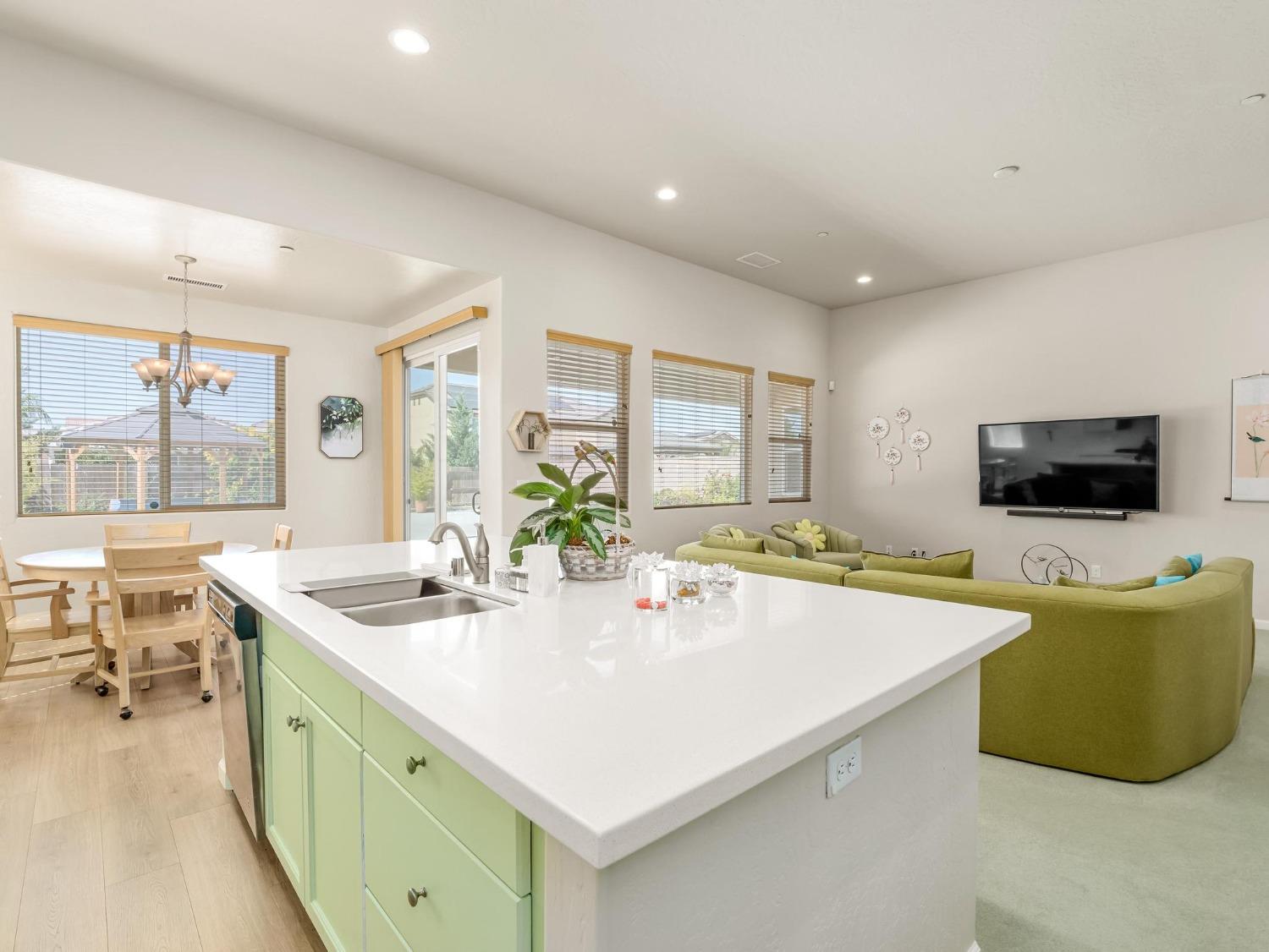 1012 Las Rosas Avenue Clovis, CA 93619 - Photo 13 of 36 a kitchen with stainless steel appliances granite countertop a sink and a refrigerator