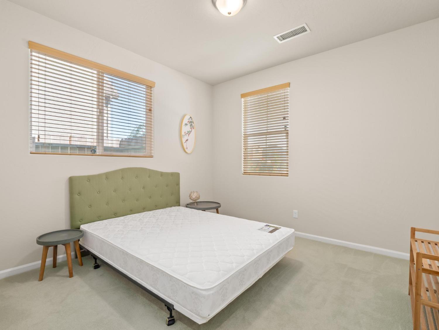 1012 Las Rosas Avenue Clovis, CA 93619 - Photo 18 of 36 a bedroom with a bed a table and chair