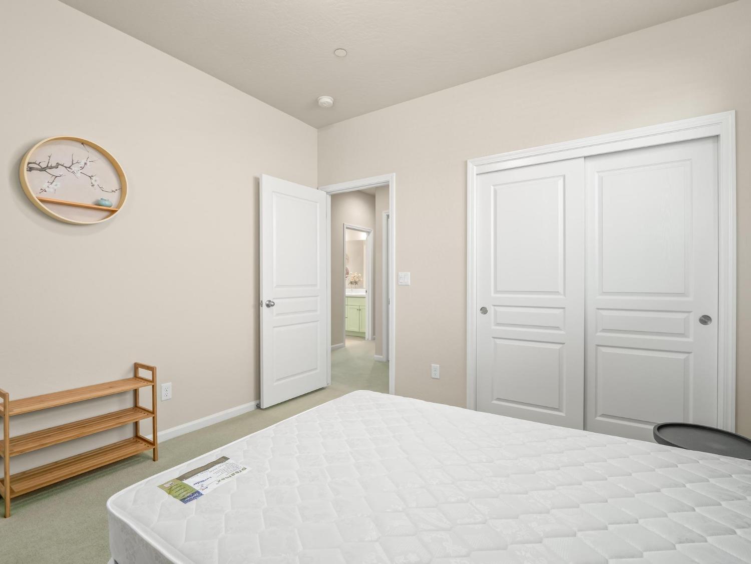 1012 Las Rosas Avenue Clovis, CA 93619 - Photo 19 of 36 a bedroom with a bed and a closet with wooden floor