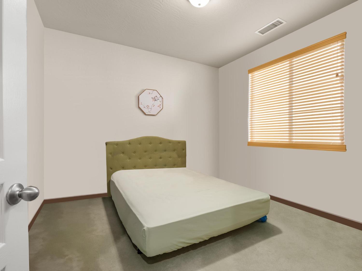 1012 Las Rosas Avenue Clovis, CA 93619 - Photo 20 of 36 a bedroom with a bed and a window