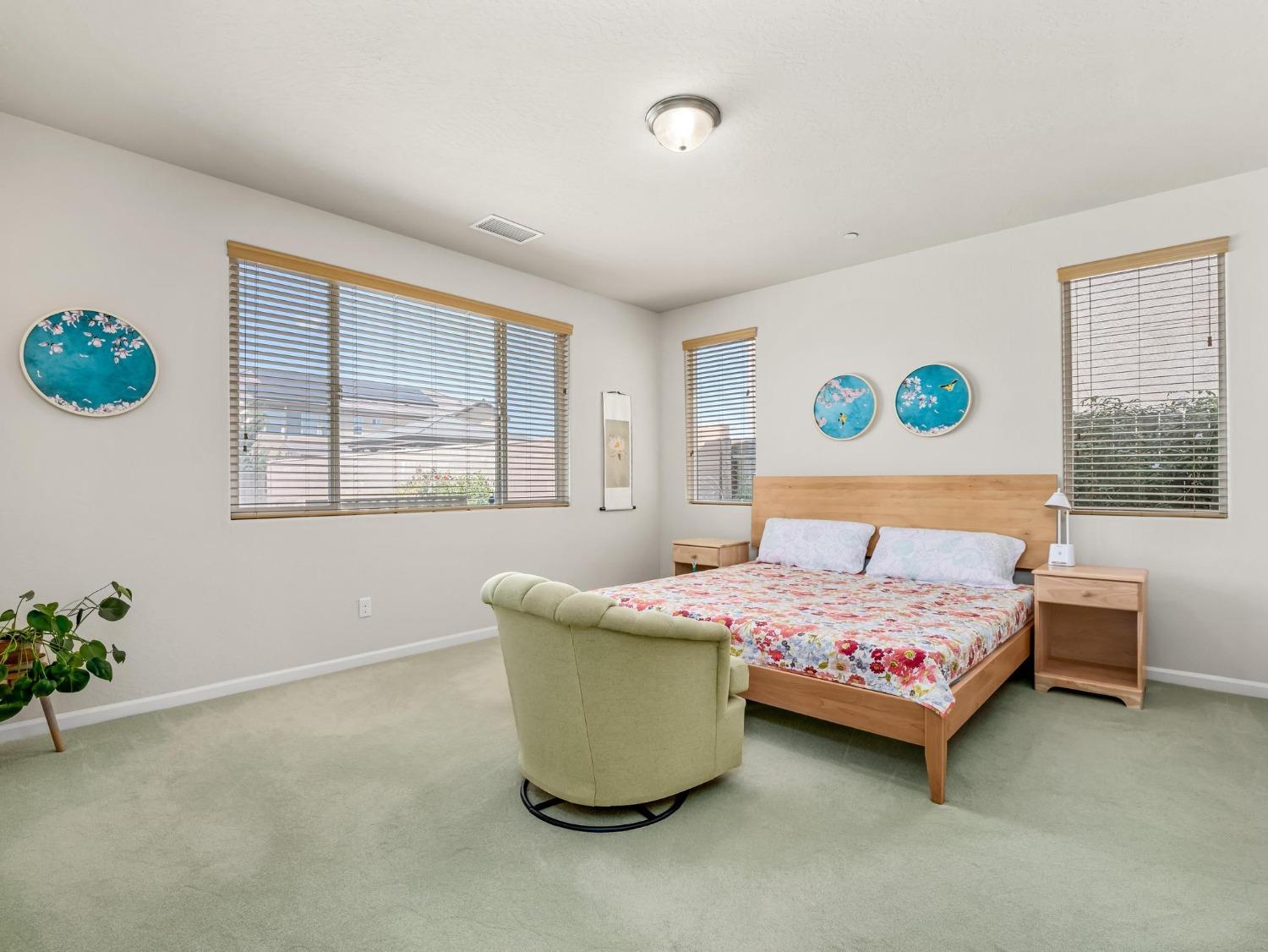 1012 Las Rosas Avenue Clovis, CA 93619 - Photo 22 of 36 a bedroom with a bed and a window