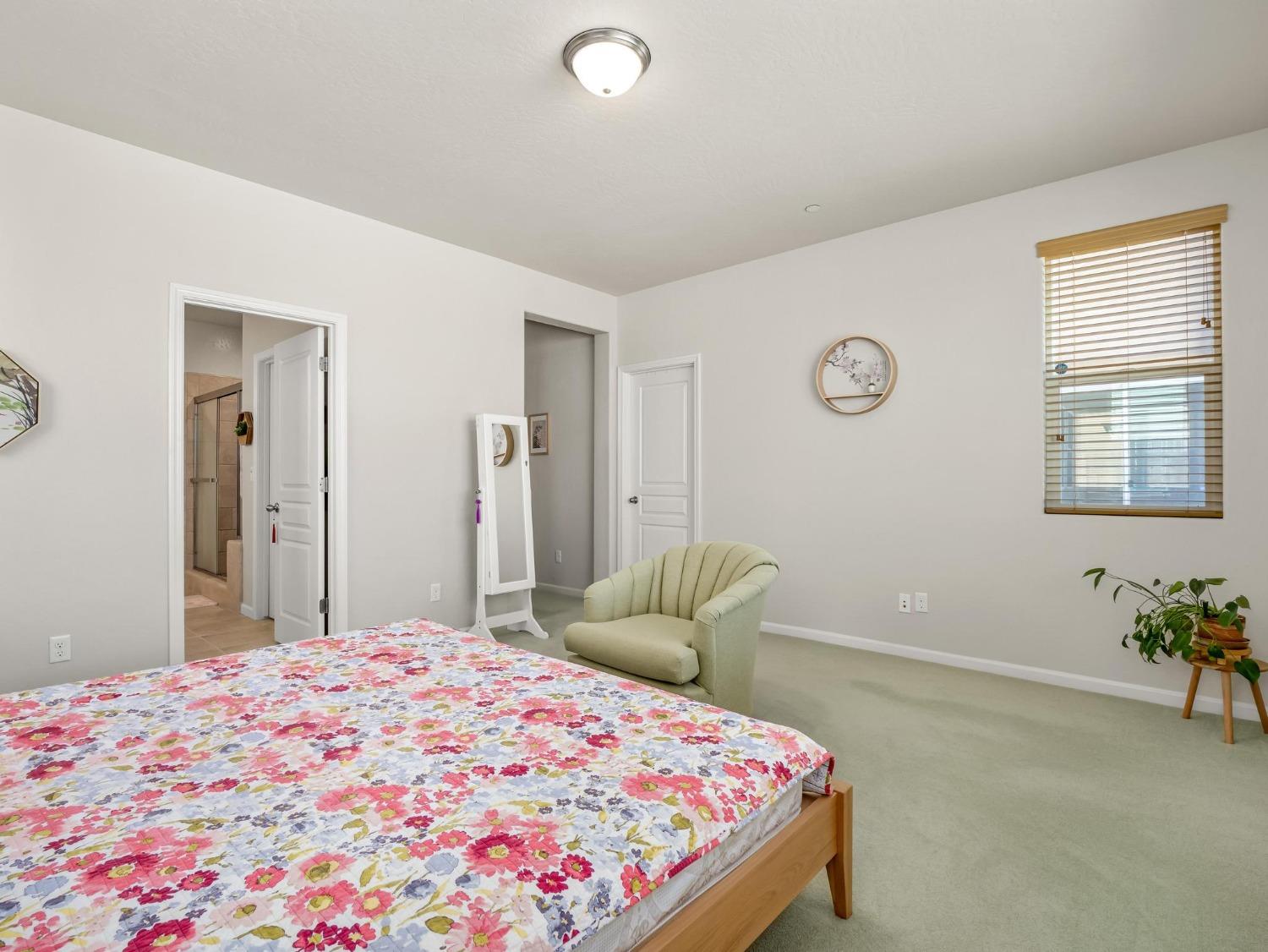 1012 Las Rosas Avenue Clovis, CA 93619 - Photo 23 of 36 a bedroom with a bed and a chandelier