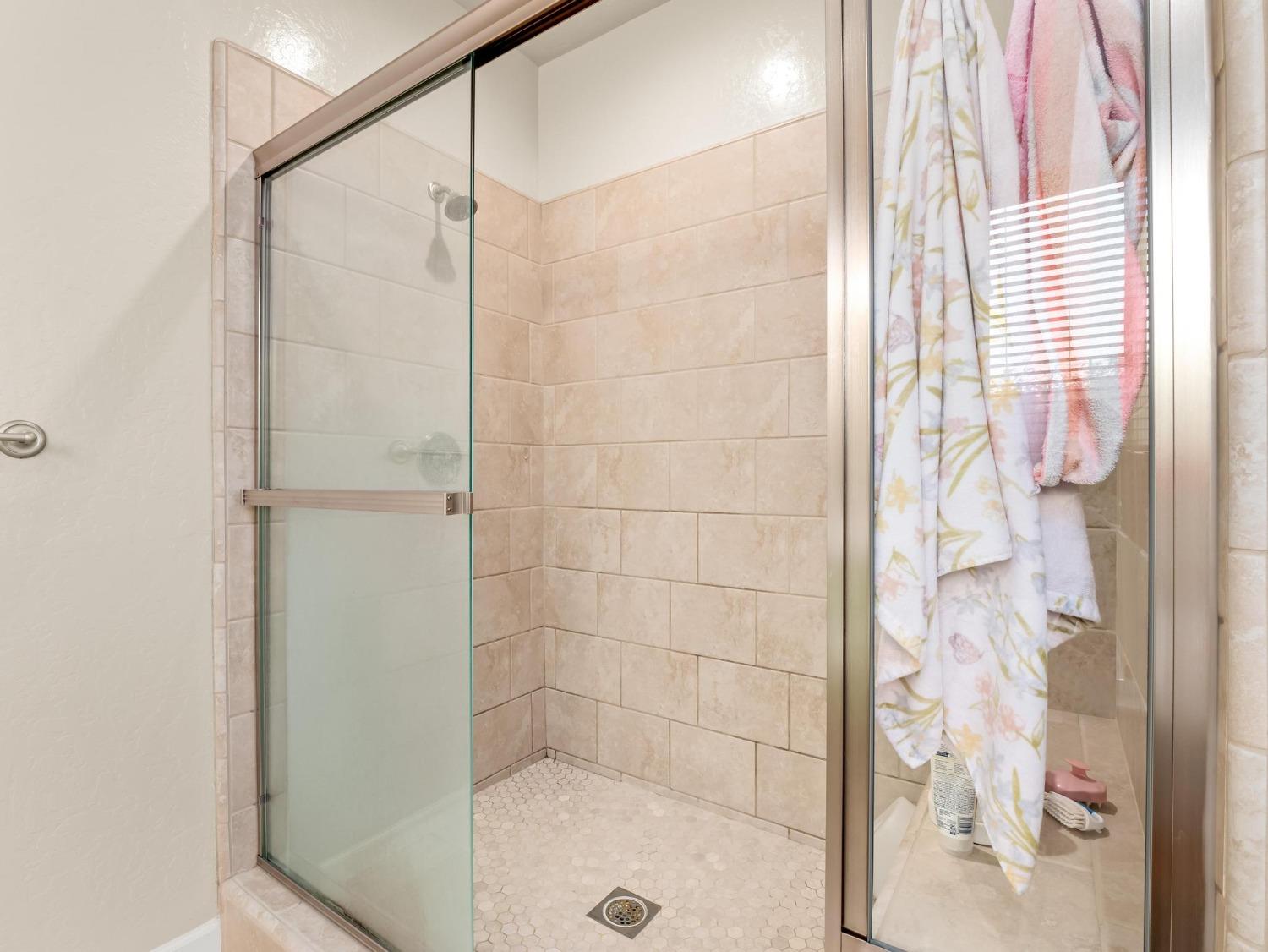 1012 Las Rosas Avenue Clovis, CA 93619 - Photo 26 of 36 a bathroom with a shower