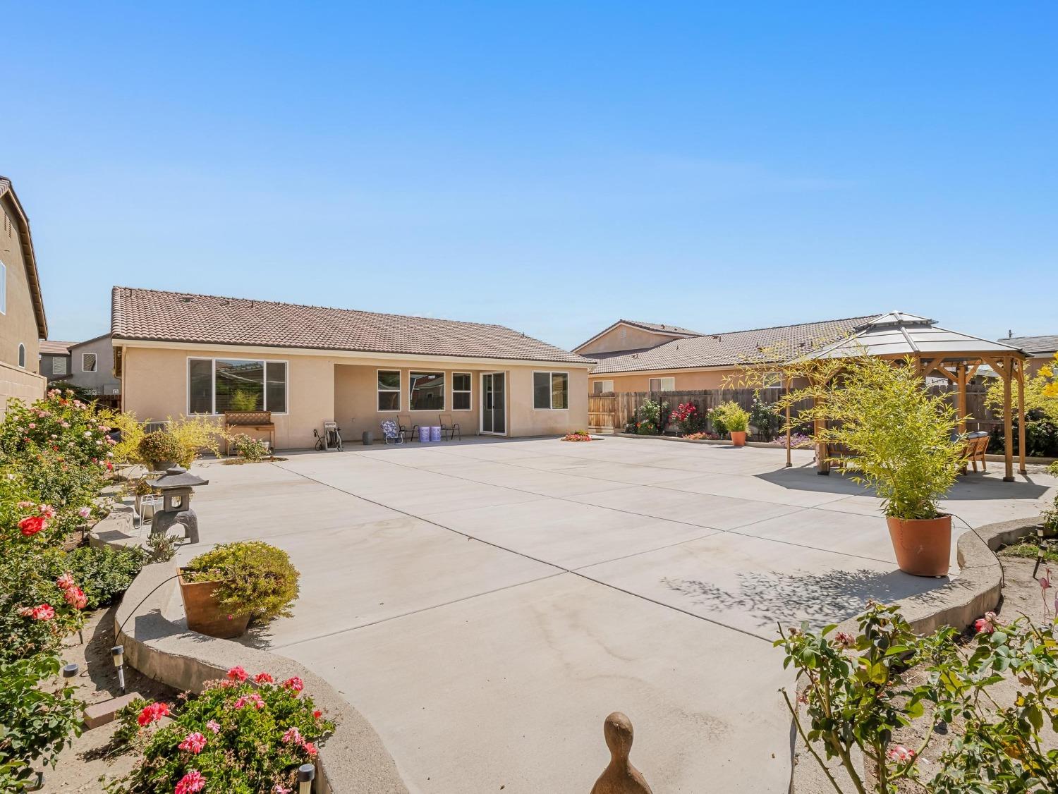 1012 Las Rosas Avenue Clovis, CA 93619 - Photo 30 of 36 a front view of a house with a yard