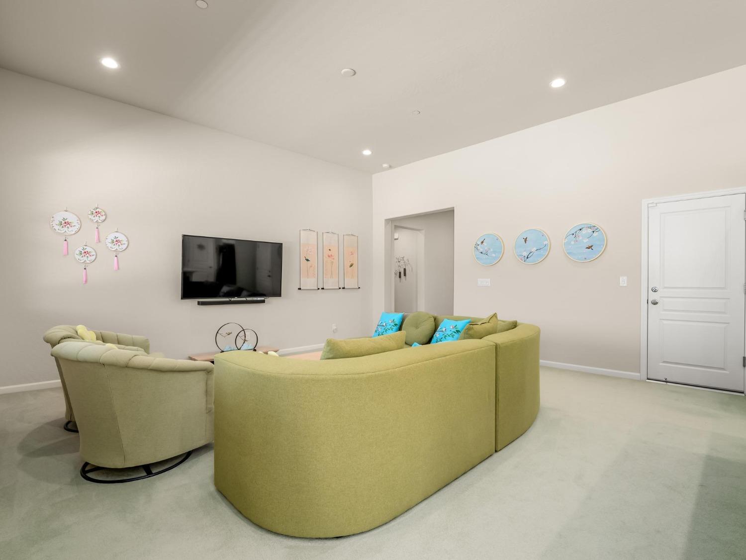 1012 Las Rosas Avenue Clovis, CA 93619 - Photo 5 of 36 a living room with a couch and a flat screen tv