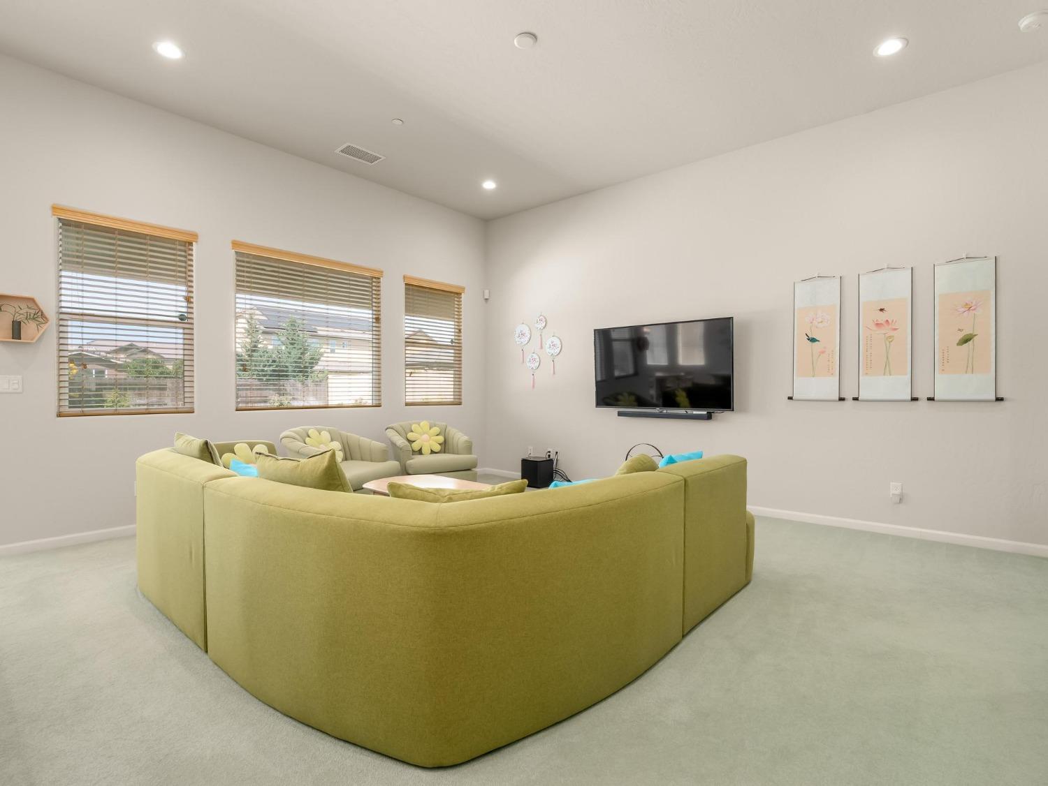 1012 Las Rosas Avenue Clovis, CA 93619 - Photo 6 of 36 a living room with furniture and a flat screen tv