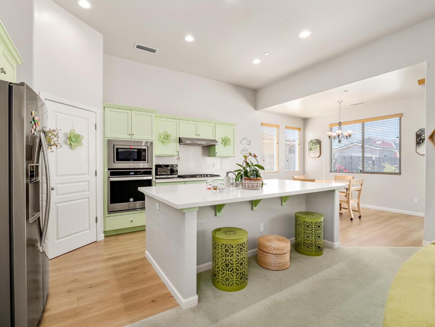 1012 Las Rosas Avenue Clovis, CA 93619 - Photo 7 of 36 a kitchen with a sink refrigerator and microwave
