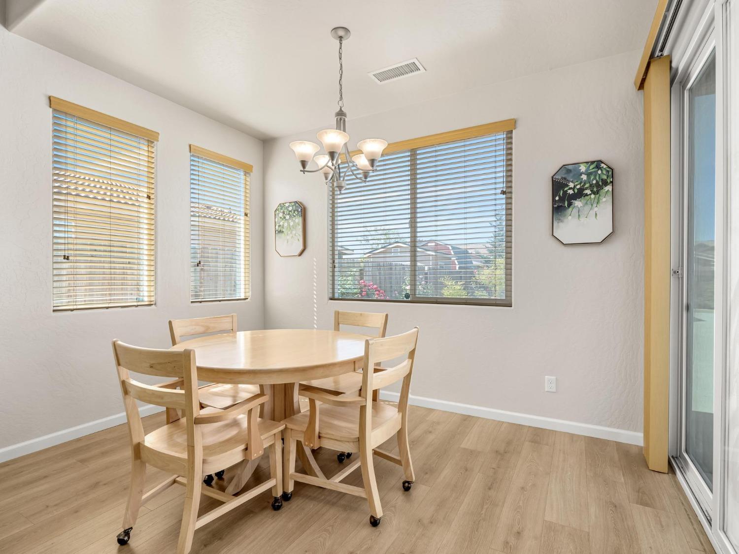 1012 Las Rosas Avenue Clovis, CA 93619 - Photo 8 of 36 a dining room with wooden floor and breakfast area