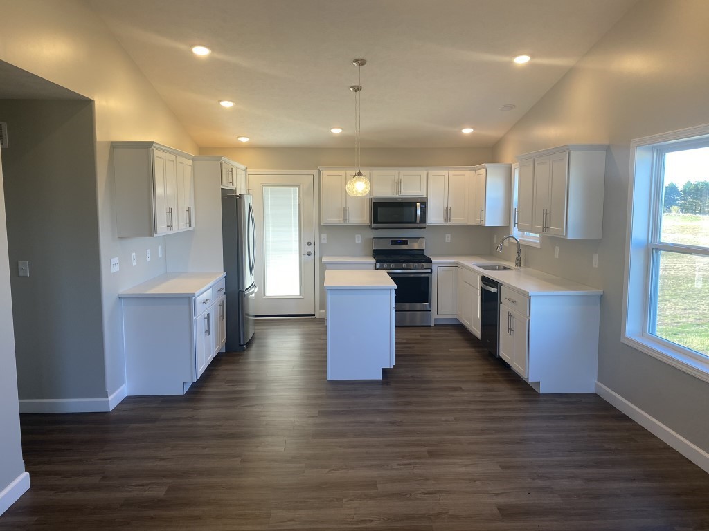 35 Winding Way Bloomington, IL 61705 - Photo 4 of 16 a kitchen with stainless steel appliances granite countertop wooden floors and white cabinets