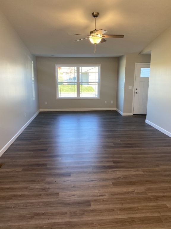 35 Winding Way Bloomington, IL 61705 - Photo 7 of 16 an empty room with wooden floor and windows