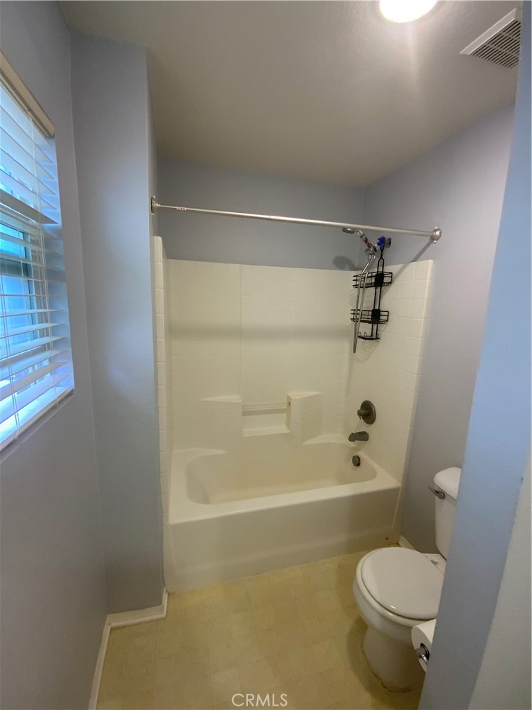 914 Sparrow Way Perris, CA 92571 - Photo 14 of 23 a bathroom with a granite countertop toilet a sink and shower