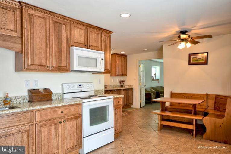 13127 Graceham Road Rocky Ridge, MD 21778 - Photo 4 of 19 a kitchen with stainless steel appliances granite countertop a stove a sink and a refrigerator