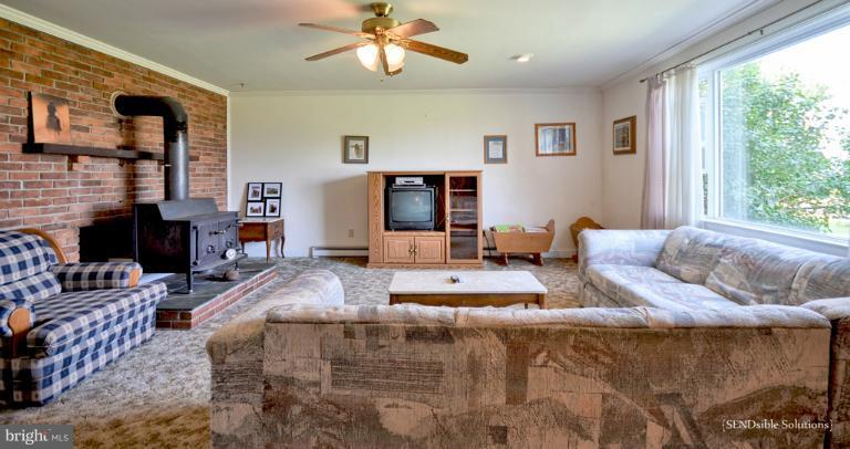 13127 Graceham Road Rocky Ridge, MD 21778 - Photo 8 of 19 a living room with furniture and a flat screen tv