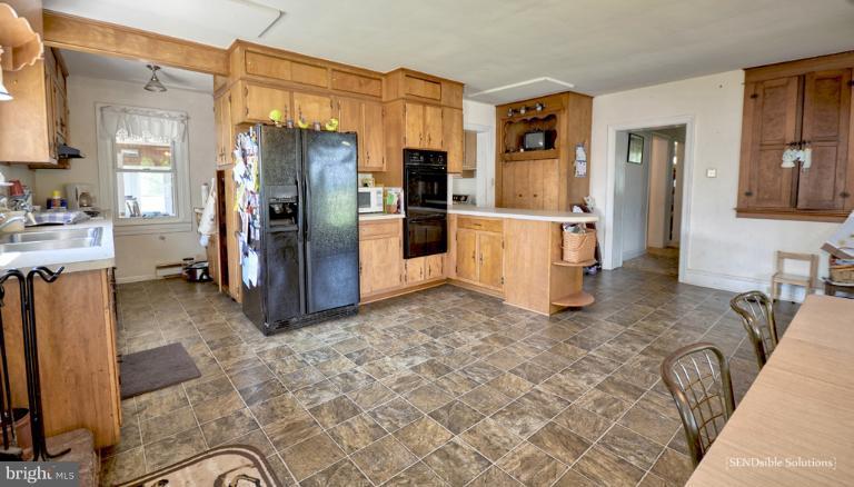 13127 Graceham Road Rocky Ridge, MD 21778 - Photo 10 of 19 a kitchen with refrigerator and cabinets