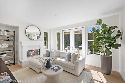 a living room with furniture a potted plant and a fireplace