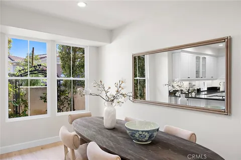 a dining room with furniture and wooden floor