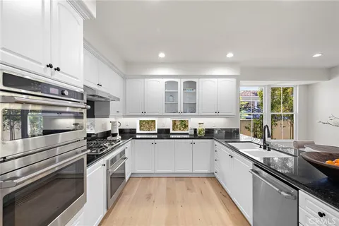a kitchen with a sink stove and cabinets