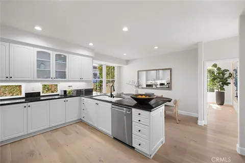 a kitchen with granite countertop a sink and cabinets
