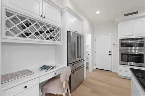 a kitchen with stainless steel appliances a refrigerator and a stove top oven