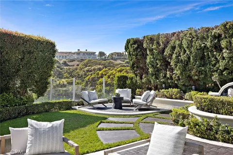 a front view of house with a garden and patio