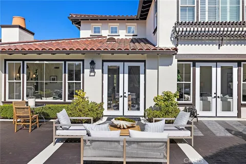 a view of a patio with couches table and chairs and potted plants