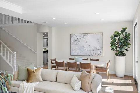 a living room with furniture plant and a window