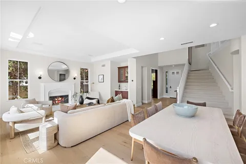 a living room with fireplace furniture and a table