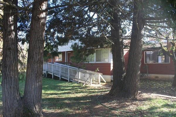 239 Dick George Road Cave Junction, OR 97523 - Photo 2 of 19 a view of house with backyard and a tree
