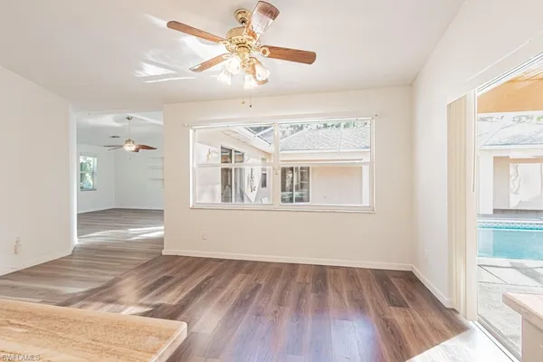 wooden floor in an empty room with a window