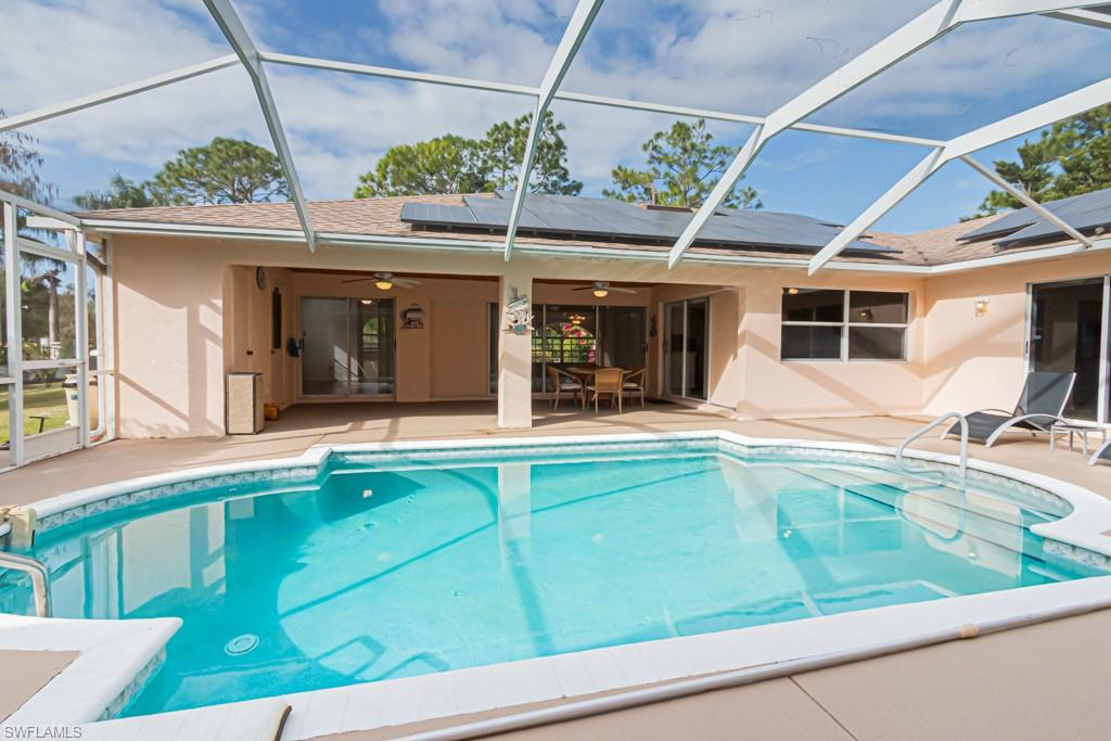 590 6th Street Northeast Naples, FL 34120 - Photo 16 of 50 Swimming pool featuring a lanai, a patio area, and outdoor dining space