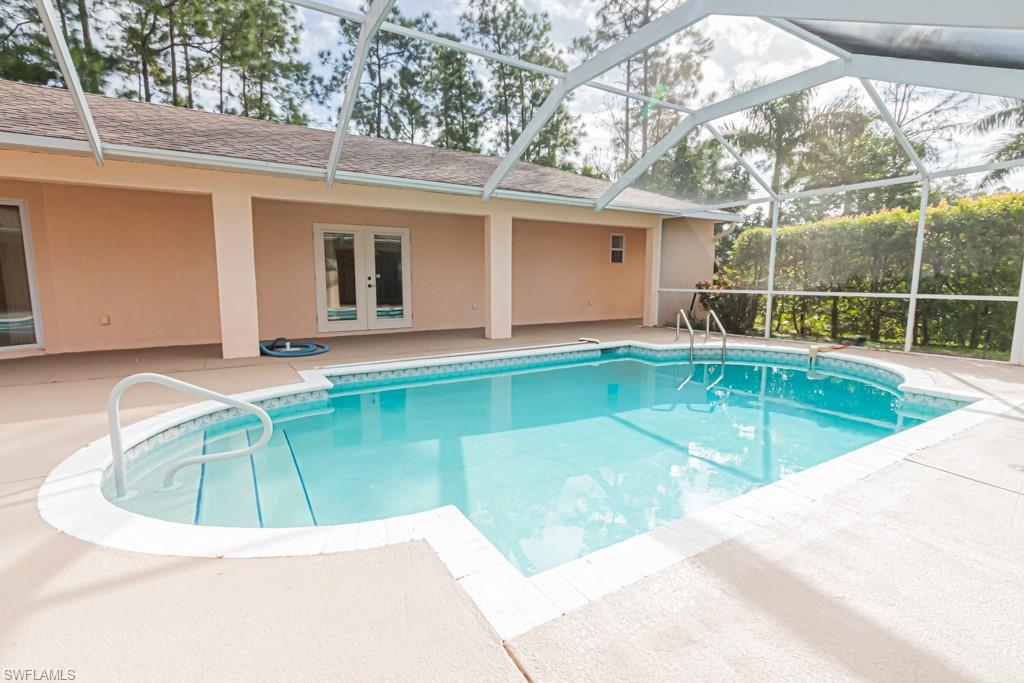 590 6th Street Northeast Naples, FL 34120 - Photo 17 of 50 Outdoor pool featuring a patio
