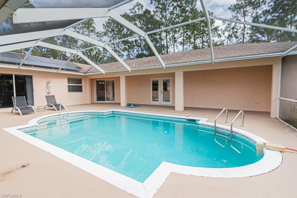 590 6th Street Northeast Naples, FL 34120 - Photo 18 of 50 Outdoor pool featuring a patio area