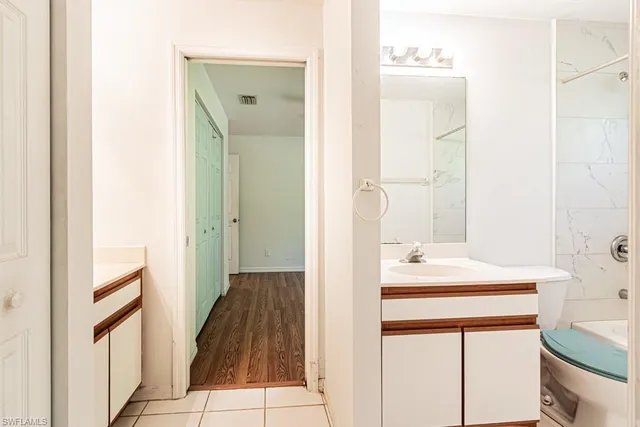 a bathroom with a sink mirror and a bathtub