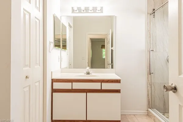 a bathroom with a double vanity sink toilet and shower
