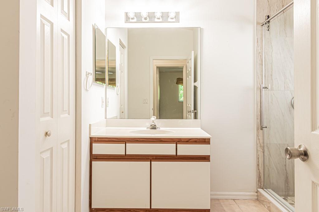 590 6th Street Northeast Naples, FL 34120 - Photo 24 of 50 Full bath with a vanity, linen closet, and light tile patterned floors