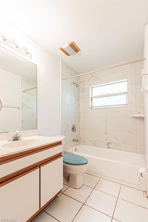 590 6th Street Northeast Naples, FL 34120 - Photo 25 of 50 Full bathroom featuring vanity, shower / bath combination, and light tile patterned floors