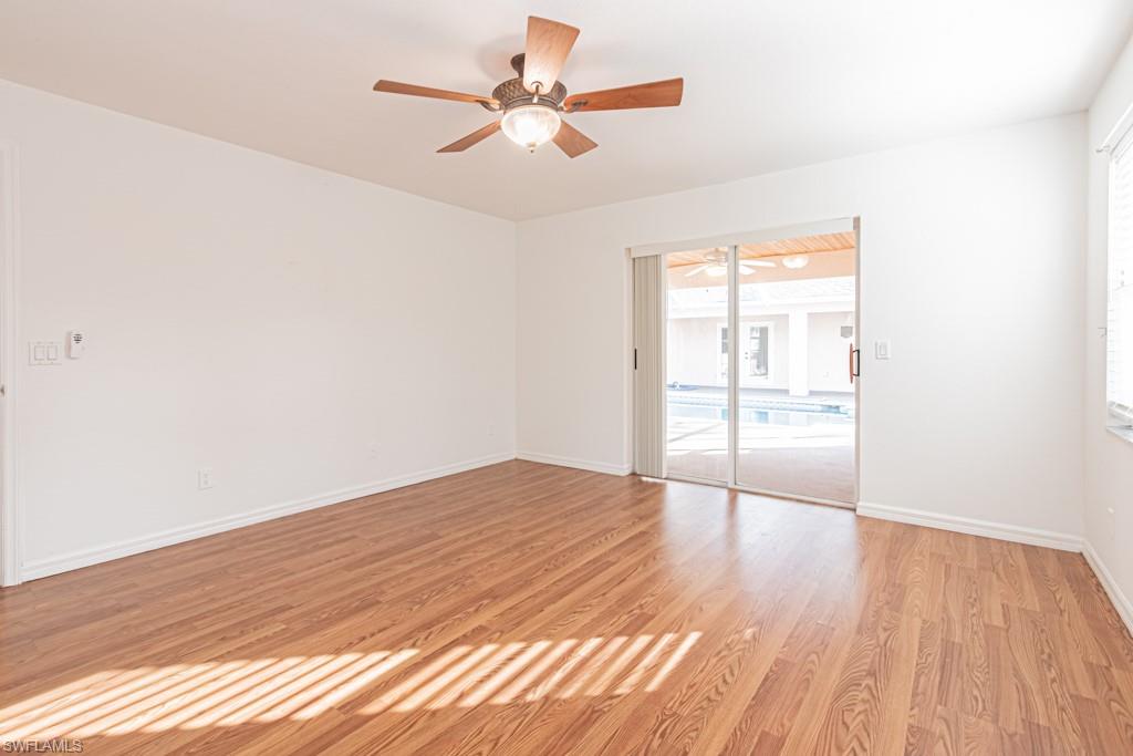 590 6th Street Northeast Naples, FL 34120 - Photo 30 of 50 Unfurnished room featuring healthy amount of natural light, light wood-type flooring, and ceiling fan