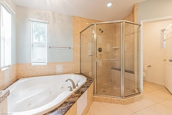 a bathroom with a granite countertop sink a toilet and shower
