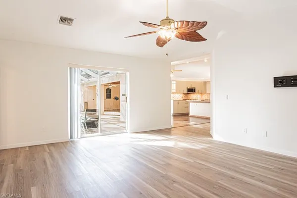 a view of a room with wooden floor