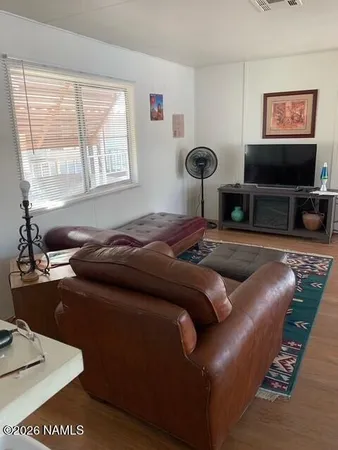 a bedroom with furniture and a flat screen tv