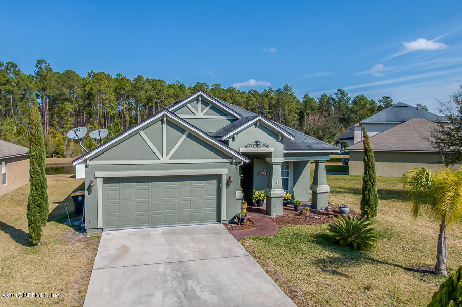 9141 Raptor Drive Jacksonville, FL 32221 - Photo 1 of 25 a front view of a house with a yard and garage