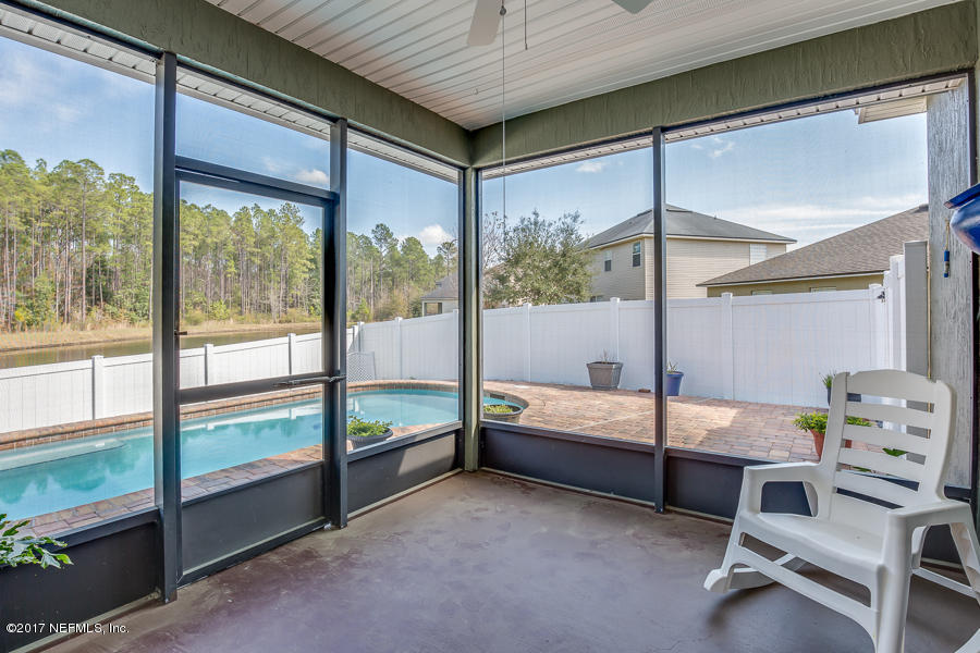 9141 Raptor Drive Jacksonville, FL 32221 - Photo 17 of 25 a bedroom with furniture and large window