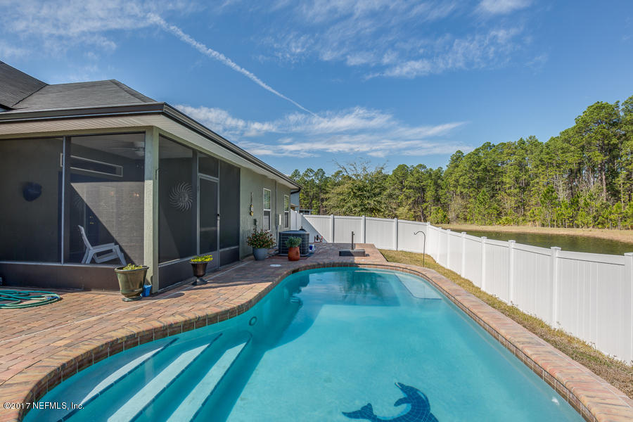 9141 Raptor Drive Jacksonville, FL 32221 - Photo 18 of 25 a view of a backyard with sitting area