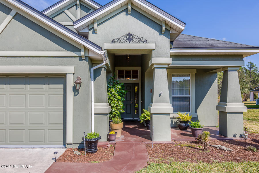 9141 Raptor Drive Jacksonville, FL 32221 - Photo 3 of 25 a front view of a house with plants