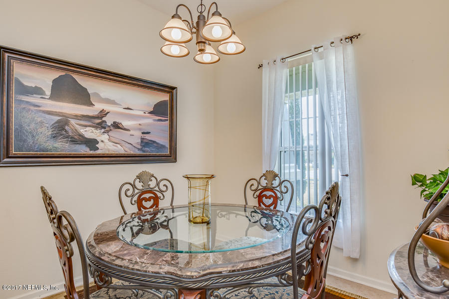 9141 Raptor Drive Jacksonville, FL 32221 - Photo 7 of 25 a view of a dining room with furniture window and wooden floor