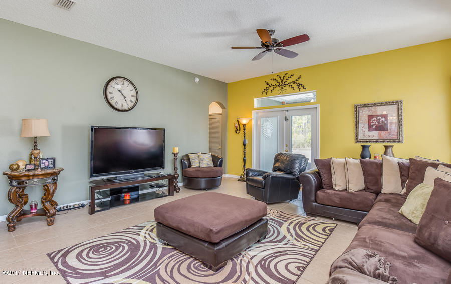 9141 Raptor Drive Jacksonville, FL 32221 - Photo 8 of 25 a living room with furniture and a flat screen tv