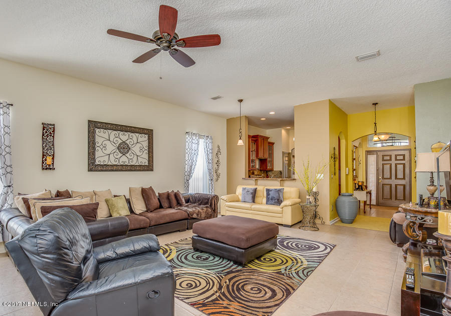 9141 Raptor Drive Jacksonville, FL 32221 - Photo 10 of 25 a living room with furniture a couch and a chandelier